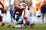 LANDOVER, MD - DECEMBER 11:   Tom Brady #12 of the New England Patriots is tackled by London Fletcher #59 of the Washington Redskins at FedExField on December 11, 2011 in Landover, Maryland.  (Photo by Patrick McDermott/Getty Images)