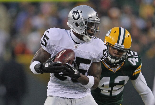 GREEN BAY, WI - DECEMBER 11: Darrius Heyward-Bey #85 of the Oakland Raiders catches a pass in front of Morgan Burnett #42 of the Green Bay Packers at Lambeau Field on December 11, 2011 in Green Bay, Wisconsin. The Packers defeated the Raiders 46-16.  (Photo by Jonathan Daniel/Getty Images)