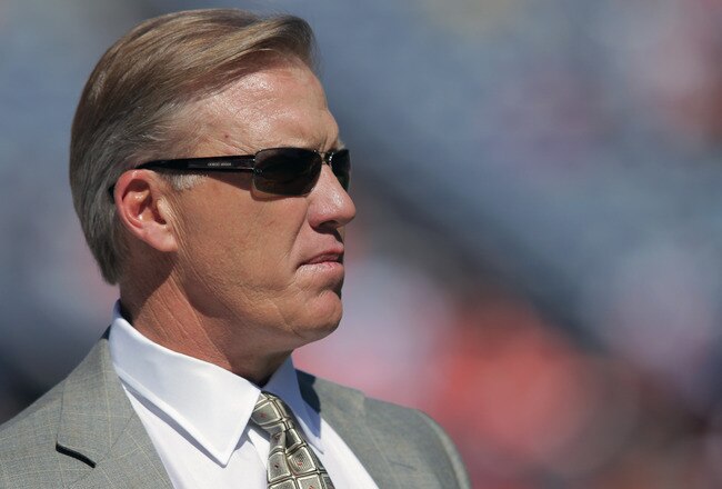 DENVER, CO - SEPTEMBER 18:  John Elway, Executive Vice President of Football Operations for the Denver Broncos, looks on from the bench as the Broncos warm up prior to facing the Cincinnati Bengals at Invesco Field at Mile High on September 18, 2011 in Denver, Colorado.  (Photo by Doug Pensinger/Getty Images)