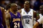 ORLANDO, FL - JUNE 11:  Kobe Bryant #24 of the Los Angeles Lakers and Dwight Howard #12 of the Orlando Magic exchange words in the second half of Game Four of the 2009 NBA Finals on June 11, 2009 at Amway Arena in Orlando, Florida.  NOTE TO USER:  User expressly acknowledges and agrees that, by downloading and or using this photograph, User is consenting to the terms and conditions of the Getty Images License Agreement.  (Photo by Chris Graythen/Getty Images)