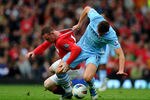 MANCHESTER, ENGLAND - OCTOBER 23:  Edin Dzeko of Manchester City tangles with Wayne Rooney of Manchester United during the Barclays Premier League match between Manchester United and Manchester City at Old Trafford on October 23, 2011 in Manchester, England. (Photo by Laurence Griffiths/Getty Images)
