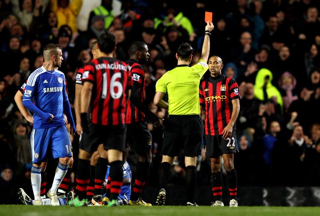 LONDON, ENGLAND - DECEMBER 12:  Gael Clichy of Manchester City is shown the red card by Referee Mark Clattenburg during the Barclays Premier League match between Chelsea and Manchester City at Stamford Bridge on December 12, 2011 in London, England.  (Photo by Julian Finney/Getty Images)