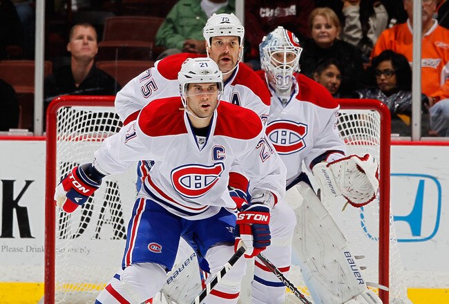 ANAHEIM, CA - NOVEMBER 30:  (L-R) Brian Gionta #21, Hal Gill #75 and goaltender Peter Budaj #30 of the Montreal Canadiens defend against the Anaheim Ducks at Honda Center on November 30, 2011 in Anaheim, California.  (Photo by Jeff Gross/Getty Images)