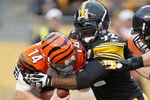 PITTSBURGH, PA - DECEMBER 04:  Andy Dalton #14 of the Cincinnati Bengals is sacked in the fourth quarter by James Harrison #92 of the Pittsburgh Steelers at Heinz Field on December 4, 2011 in Pittsburgh, Pennsylvania. Pittsburgh won the game 35-7. (Photo by Gregory Shamus/Getty Images)