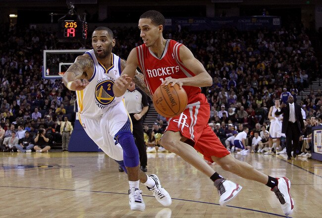 OAKLAND, CA - DECEMBER 20:  Kevin Martin #12 of the Houston Rockets dribbles past Acie Law #2 of the Golden State Warriors at Oracle Arena on December 20, 2010 in Oakland, California. NOTE TO USER: User expressly acknowledges and agrees that, by downloading and or using this photograph, User is consenting to the terms and conditions of the Getty Images License Agreement.  (Photo by Ezra Shaw/Getty Images)