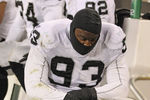 GREEN BAY, WI - DECEMBER 11: Tommy Kelly #93 of the Oakland Raiders sits on the sidelines during a game against the Green Bay Packers at Lambeau Field on December 11, 2011 in Green Bay, Wisconsin. The Packers defeated the Raiders 46-16. (Photo by Jonathan Daniel/Getty Images)