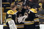 BOSTON, MA - DECEMBER 13:  Tuukka Rask #40 of the Boston Bruins is congratulated by teammates Tim Thomas #30 and Patrice Bergeron #37 after Rask shut out the Los Angeles Kings on December 13, 2011 at TD Garden in Boston, Massachusetts. The Boston Bruins defeated the Los Angeles Kings 3-0.  (Photo by Elsa/Getty Images)