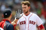 BOSTON, MA - JUNE 01:  Jed Lowrie #12 of the Boston Red Sox is congratulated after he scored in the second inning against the Chicago White Sox on June 1, 2011 at Fenway Park in Boston, Massachusetts.  (Photo by Elsa/Getty Images)