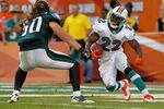 MIAMI GARDENS, FL - DECEMBER 11:  Reggie Bush #22 of the Miami Dolphins runs away from Casey Matthews #50 of the Philadelphia Eagles during a game  at Sun Life Stadium on December 11, 2011 in Miami Gardens, Florida.  (Photo by Mike Ehrmann/Getty Images)