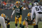 GREEN BAY, WI - DECEMBER 11:  Aaron Rodgers  #12 of the Green Bay Packers calls out a defensive alignment against the Oakland Raiders at Lambeau Field on December 11, 2011 in Green Bay, Wisconsin. The Packers defeated the Raiders 46-16.  (Photo by Jonathan Daniel/Getty Images)