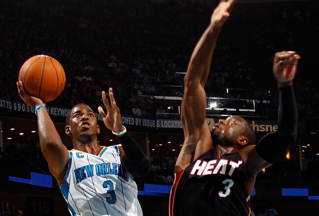 NEW ORLEANS - NOVEMBER 05:  Chris Paul #3 of the New Orleans Hornets shoots the ball over Dwyane Wade #3 of the Miami Heat at the New Orleans Arena on November 5, 2010 in New Orleans, Louisiana.  NOTE TO USER: User expressly acknowledges and agrees that, by downloading and/or using this Photograph, User is consenting to the terms and conditions of the Getty Images License Agreement.  (Photo by Chris Graythen/Getty Images)