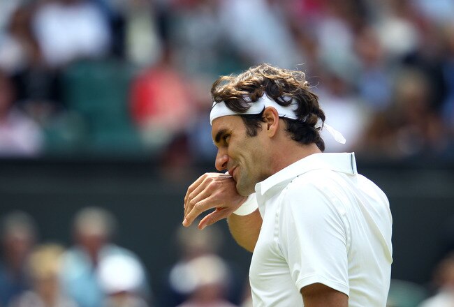 LONDON, ENGLAND - JUNE 29:  Roger Federer of Switzerland wipes his face during his quarterfinal round match against Jo-Wilfried Tsonga of France on Day Nine of the Wimbledon Lawn Tennis Championships at the All England Lawn Tennis and Croquet Club on June 29, 2011 in London, England.  (Photo by Julian Finney/Getty Images)