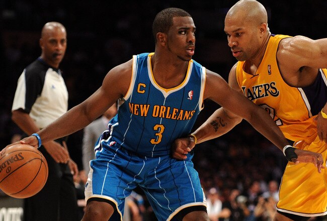 LOS ANGELES, CA - APRIL 26:  Chris Paul #3 of the New Orleans Hornets moves the ball against Derek Fisher #2 of the Los Angeles Lakers in Game Five of the Western Conference Quarterfinals in the 2011 NBA Playoffs on April 26, 2011 at Staples Center in Los Angeles, California. NOTE TO USER: User expressly acknowledges and agrees that, by downloading and or using this photograph, User is consenting to the terms and conditions of the Getty Images License Agreement.  (Photo by Harry How/Getty Images)