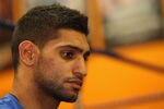 BOLTON, ENGLAND - DECEMBER 14:  Amir Khan faces the media during a press conference to reflect on his defeat by Lamont Peterson to lose his WBA and IBF light-welterweight titles at the Gloves Community Centre on December 14, 2011 in Bolton, England.  (Photo by Alex Livesey/Getty Images)