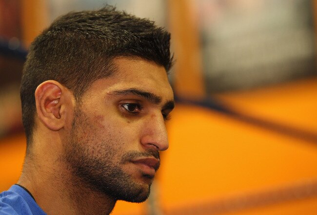 BOLTON, ENGLAND - DECEMBER 14:  Amir Khan faces the media during a press conference to reflect on his defeat by Lamont Peterson to lose his WBA and IBF light-welterweight titles at the Gloves Community Centre on December 14, 2011 in Bolton, England.  (Photo by Alex Livesey/Getty Images)