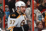OTTAWA, CANADA - DECEMBER 14: Patrice Bergeron #37 of the Boston Bruins celebrates his third period goal with team mate Brad Marchand #63 during an NHL game against the Ottawa Senators at Scotiabank Place on December 14, 2011 in Ottawa, Ontario, Canada.  (Photo by Jana Chytilova/Freestyle Photography/Getty Images)