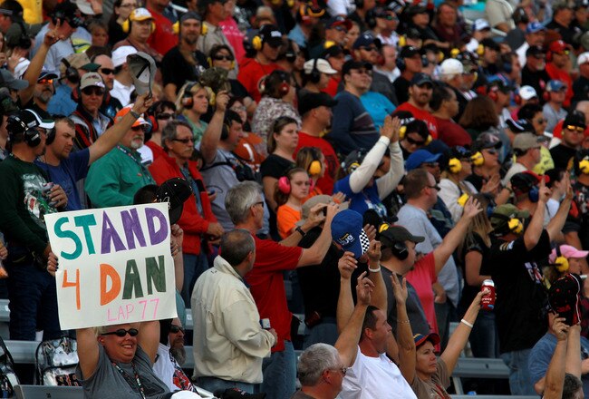 FORT WORTH, TX - NOVEMBER 06:  Fans Stand for Dan Wheldon on Lap 77 of the NASCAR Sprint Cup Series AAA Texas 500 at Texas Motor Speedway on November 6, 2011 in Fort Worth, Texas.  (Photo by Ronald Martinez/Getty Images)