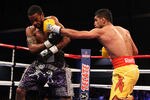 WASHINGTON, DC - DECEMBER 10:  Amir Khan punches Lamont Peterson during their WBA Super Lightweight and IBF Junior Welterweight title fight at Washington Convention Center on December 10, 2011 in Washington, DC.  (Photo by Al Bello/Getty Images)