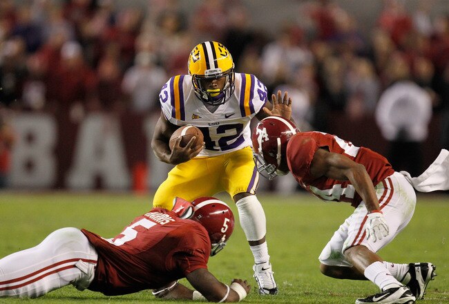 TUSCALOOSA, AL - NOVEMBER 05:  Michael Ford #42 of the LSU Tigers is stopped by Jerrell Harris #5 and DeQuan Menzie #24 of the Alabama Crimson Tide during the game at Bryant-Denny Stadium on November 5, 2011 in Tuscaloosa, Alabama.  (Photo by Streeter Lecka/Getty Images)