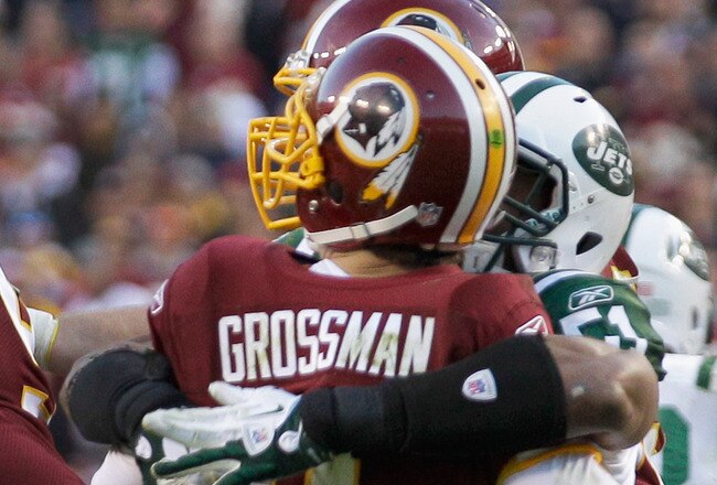 LANDOVER, MD - DECEMBER 04:  Aaron Maybin #51 of the New York Jets hits and forces a fumble on  Rex Grossman #8 of the Washington Redskins during the second half at FedExField on December 4, 2011 in Landover, Maryland.  (Photo by Rob Carr/Getty Images)