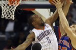 CHARLOTTE, NC - NOVEMBER 24:  Timofey Mozgov #25 of the New York Knicks has his shot blocked by Dominic McGuire #5 of the Charlotte Bobcats during their game at Time Warner Cable Arena on November 24, 2010 in Charlotte, North Carolina.  NOTE TO USER: User expressly acknowledges and agrees that, by downloading and/or using this Photograph, User is consenting to the terms and conditions of the Getty Images License Agreement.  (Photo by Streeter Lecka/Getty Images)