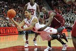 LOUISVILLE, KY - DECEMBER 07: Peyton Siva #3 of the Louisville Cardinals shoots the ball while defended by Alex Young #5 of the IUPUI Jaguars during the game at the KFC YUM! Center on December 7, 2011 in Louisville, Kentucky.  (Photo by Andy Lyons/Getty Images)