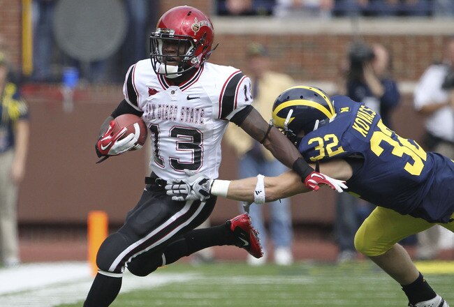 ANN ARBOR, MI - SEPTEMBER 24: Ronnie Hillman #13 of San Diego State runs for a first down as Jordan Kovacs #32 of the Michigan Wolverines attempts to make the stop runs during the first half of the game at Michigan Stadium on September 24, 2011 in Ann Arbor, Michigan.  (Photo by Leon Halip/Getty Images)
