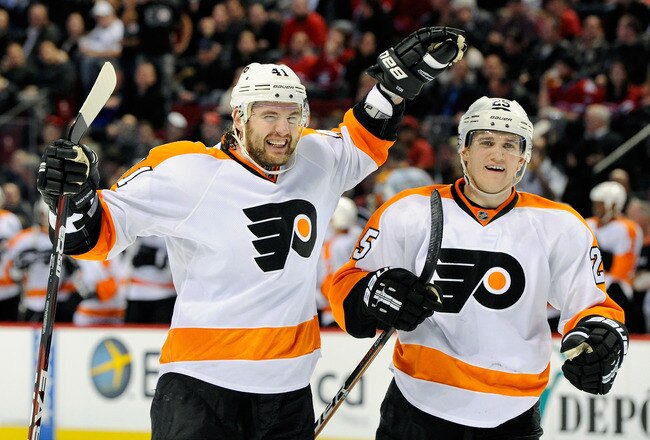 MONTREAL, CANADA - DECEMBER 15:  Andrej Meszaros #41 of the Philadelphia Flyers celebrates his game winning goal with team mate Matt Carle #25 during the NHL game against the Montreal Canadiens at the Bell Centre on December 15, 2011 in Montreal, Quebec, Canada.  The Flyers defeated the Canadiens 4-3.  (Photo by Richard Wolowicz/Getty Images)