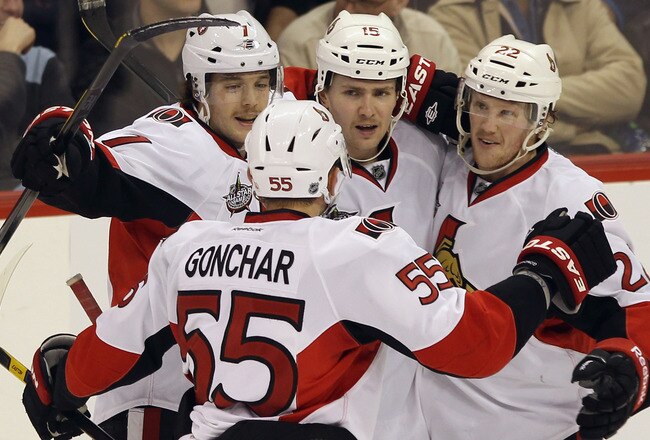 WINNIPEG, CANADA - NOVEMBER 29: (L-R) David Rundblad #7, Sergei Gonchar #55, Zack Smith #15 and Erik Condra #22 of the Ottawa Senators celebrate the game winning power play goal by Smith at 13:45 of the third period against the Winnipeg Jets at the MTS Centre on November 29, 2011 in Winnipeg, Canada. The Senators defeated the Jets 6-4.