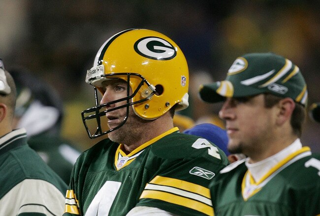 GREEN BAY, WI - NOVEMBER 6:  Quarterbacks Brett Favre #4 and Aaron Rodgers #12 of the Green Bay Packers watch the final minutes of a game against the Pittsburgh Steelers from the sideline November 6, 2005 at Lambeau Field in Green Bay, Wisconsin. The Steelers defeated the Packers, 20-10.  (Photo by Jonathan Daniel/Getty Images)