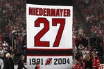 NEWARK, NJ - DECEMBER 16:  Scott Niedermayer (R) takes part in his jersey retirement ceremony by the New Jersey Devils prior to the game against the Dallas Stars at the Prudential Center on December 16, 2011 in Newark, New Jersey.  (Photo by Bruce Bennett/Getty Images)