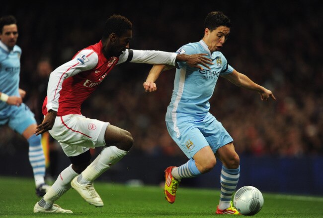 LONDON, ENGLAND - NOVEMBER 29:  Johan Djourou of Arsenal battles with Samir Nasri of Manchester City during the Carling Cup Quarter Final match between Arsenal and Manchester City at Emirates Stadium on November 29, 2011 in London, England.  (Photo by Michael Regan/Getty Images)