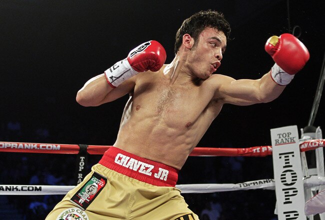 HOUSTON - NOVEMBER 19:  Julio Chavez Jr. ,left, just misses with a left hook on Peter Manfredo Jr. at Reliant Arena at Reliant Park on November 19, 2011 in Houston, Texas.  (Photo by Bob Levey/Getty Images)
