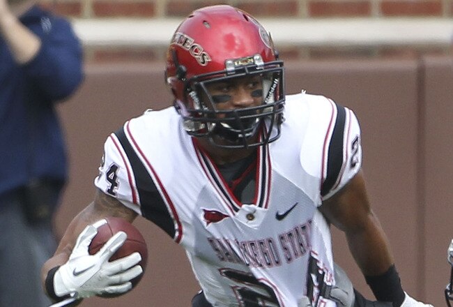 ANN ARBOR, MI - SEPTEMBER 24: Colin Lockett #24 of San Diego State runs for a first down as Thomas Gordon #30 of the Michigan Wolverines attempts to make the stop runs during the first half of the game at Michigan Stadium on September 24, 2011 in Ann Arbor, Michigan.  (Photo by Leon Halip/Getty Images)