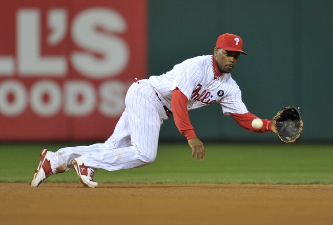 PHILADELPHIA, PA - OCTOBER 02: Jimmy Rollins #11 of the Philadelphia Phillies fields the ball during Game Two of the National League Division Series against the St. Louis Cardinals at Citizens Bank Park on October 2, 2011 in Philadelphia, Pennsylvania. The Cardinals won 5-4.  (Photo by Drew Hallowell/Getty Images)