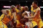 CHICAGO, IL - APRIL 26: Taj Gibson #22 of the Chicago Bulls battles for the ball with (L-R) Dahntay Jones #1, Danny Granger #33 and Josh McRoberts #32 of the Indiana Pacers in Game Five of the Eastern Conference Quarterfinals in the 2011 NBA Playoffs at the United Center on April 26, 2011 in Chicago, Illinois. The Bulls defeated the Pacers 116-89. NOTE TO USER: User expressly acknowledges and agrees that, by downloading and/or using this photograph, User is consenting to the terms and conditions of the Getty Images License Agreement.  (Photo by Jonathan Daniel/Getty Images)