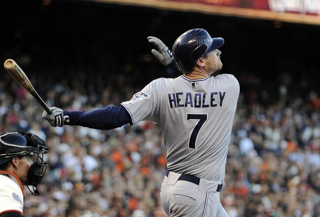 SAN FRANCISCO, CA - JULY 6: Chase Headley #7 of the San Diego Padres hits a sacrifice fly to right field, driving in teammate Chirs Denorfia #13 from third base against the San Francisco Giants in the third inning during a MLB baseball game at AT&T Park July 6, 2011 in San Francisco, California. (Photo by Thearon W. Henderson/Getty Images)