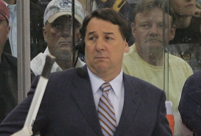 PITTSBURGH - MAY 04: TV commentator Mike Milbury works between the benches in the game between the Pittsburgh Penguins and the New York Rangers during game five of the Eastern Conference Semifinals of the 2008 NHL Stanley Cup Playoffs on May 4, 2008 at the Mellon Arena in Pittsburgh, Pennsylvania. The Penguins defeated the Rangers 3-2 in overtime to win the series 4 games to 1.  (Photo by Bruce Bennett/Getty Images)