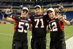 DETROIT, MI - DECEMBER 02:  Pat Schiller #53, Scott Wedige #71 and Chandler Harnish #12 of the Northern Illinois Huskies pose for a photo after winning the MAC Championship game against the Ohio Bobcats at Ford Field on December 2, 2011 in Detroit, Michigan. The Huskies defeated the Bobcats 23-20.  (Photo by Mark A. Cunningham/Getty Images)