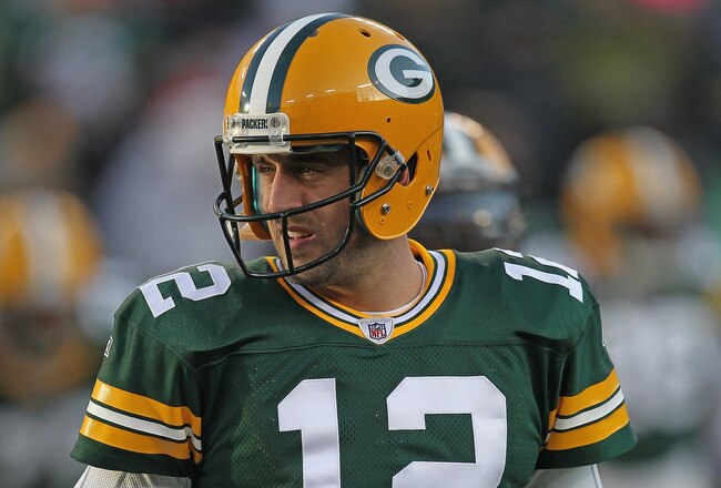 GREEN BAY, WI - DECEMBER 11:  Aaron Rodgers #12 of the Green Bay Packers participates in warm-ups before a game against the Oakland Raiders at Lambeau Field on December 11, 2011 in Green Bay, Wisconsin. The Packers defeated the Raiders 46-16.  (Photo by Jonathan Daniel/Getty Images)