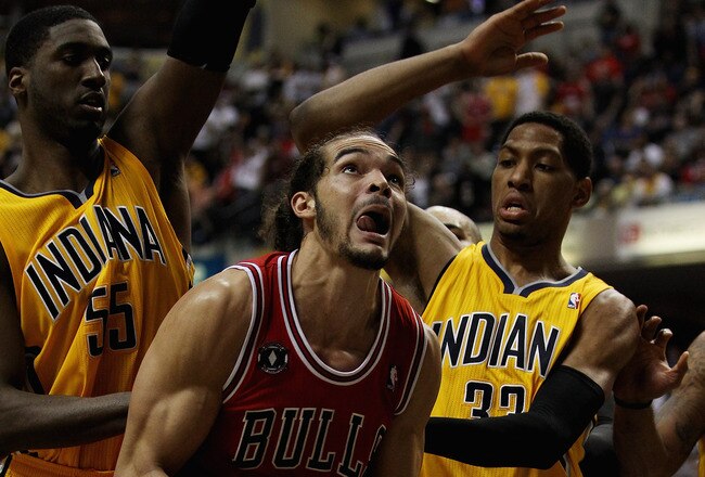 INDIANAPOLIS, IN - APRIL 23: Joakim Noah #13 of the Chicago Bulls goes up for a shot against Roy Hibbert #55 and Danny Granger #33 of the Indiana Pacers in Game Four of the Eastern Conference Quarterfinals in the 2011 NBA Playoffs at Conseco Fieldhouse on April 23, 2011 in Indianapolis, Indiana. The Pacers defeated the Bulls 89-84. NOTE TO USER: User expressly acknowledges and agrees that, by downloading and/or using this photograph, User is consenting to the terms and conditions of the Getty Images License Agreement. (Photo by Jonathan Daniel/Getty Images)