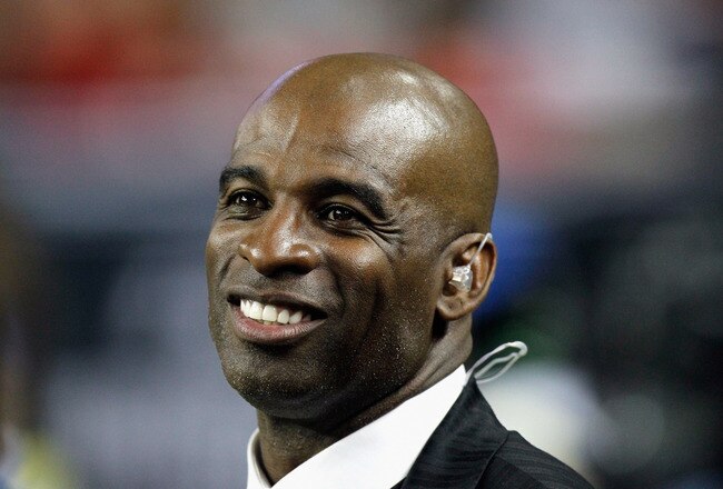 ATLANTA - NOVEMBER 11:  NFL network broadcaster and former Atlanta Falcons player Deion Sanders watches from the sidelines after being inducted into the Falcons Ring of Honor during halftime of the game against the Baltimore Ravens at Georgia Dome on November 11, 2010 in Atlanta, Georgia.  (Photo by Kevin C. Cox/Getty Images)