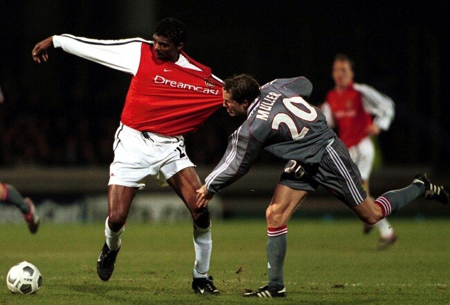 13 Feb 2001:  Kanu of Arsenal holds off the challenge of Patrick Muller of Lyon during the match between Olympique Lyonnais and Arsenal in the UEFA Champions League Group C at the Stade Municipal de Gerland, Lyon, France. Mandatory Credit: Phil Cole/ALLSPORT