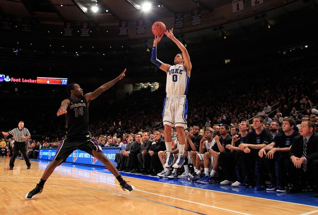 NEW YORK, NY - DECEMBER 10: Austin Rivers #0 of the Duke Blue Devils shoots over Tony Wroten #14 of the Washington Huskies at Madison Square Garden on December 10, 2011 in New York City.  (Photo by Chris Trotman/Getty Images)