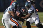 CHICAGO, IL - DECEMBER 18: Kahlil Bell #32 of the Chicago Bears is tackled by Brandon Mebane #92 and David Hawthorne #57 of the Seattle Seahawks at Soldier Field on December18, 2011 in Chicago, Illinois. The Seahawks defeated the Bears 38-14.(Photo by Jonathan Daniel/Getty Images)