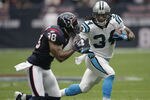 HOUSTON - DECEMBER 18:  Running back DeAngelo Wiliams #34 of the Carolina Panthers looks for room to run as Danieal Manning #38 of the Houston Texans looks to maket the stop at Reliant Stadium on December 18, 2011 in Houston, Texas.  (Photo by Bob Levey/Getty Images)