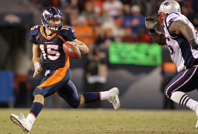 DENVER, CO - DECEMBER 18: Tim Tebow #15 of the Denver Broncos tries to escape the pass rush of Vince Wilfork #75 of the New England Patriots on December 18, 2011 during the first half at Sports Authority Field at Mile High in Denver, Colorado. The New England Patriots won the game 41-23. (Photo by Marc Piscotty/Getty Images)