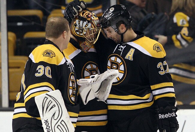 BOSTON, MA - DECEMBER 13:  Tuukka Rask #40 of the Boston Bruins is congratulated by teammates Tim Thomas #30 and Patrice Bergeron #37 after Rask shut out the Los Angeles Kings on December 13, 2011 at TD Garden in Boston, Massachusetts. The Boston Bruins defeated the Los Angeles Kings 3-0.  (Photo by Elsa/Getty Images)