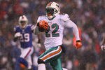 ORCHARD PARK, NY - DECEMBER 18: Reggie Bush #22 of the Miami Dolphins runs for a 76-yard touchdown during their NFL game against the Buffalo Bills at Ralph Wilson Stadium on December 18, 2011 in Orchard Park, New York. (Photo by Tom Szczerbowski/Getty Images)