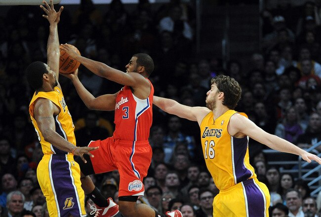 LOS ANGELES, CA - DECEMBER 19:  Chris Paul #3 of the Los Angeles Clippers drives to the basket on Metta World Peace #15 and Pau Gasol #16 of the Los Angeles Lakers at Staples Center on December 19, 2011 in Los Angeles, California.  The Clippers beat the Lakers 114-95.  (Photo by Harry How/Getty Images)